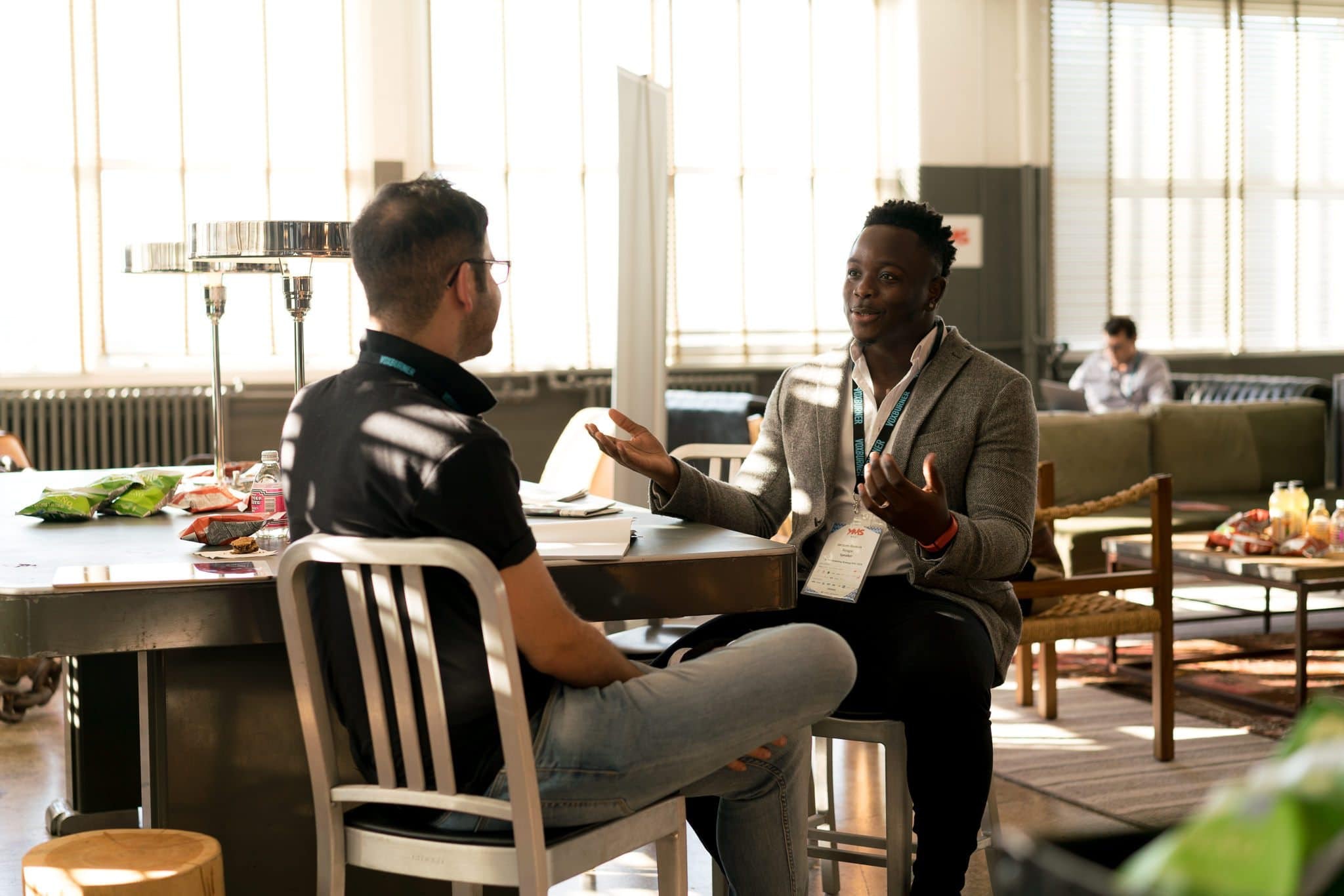 Two men sitting in a cafe discussing business 
