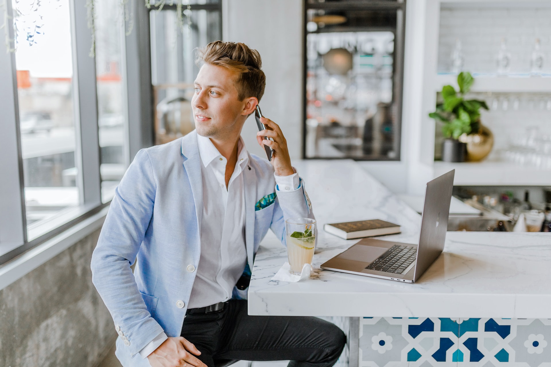 Real Estate agent with a mobile phone sitting in a office