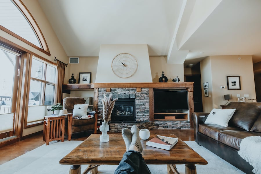 A pair of feet on a coffee table in a vacation rental interior