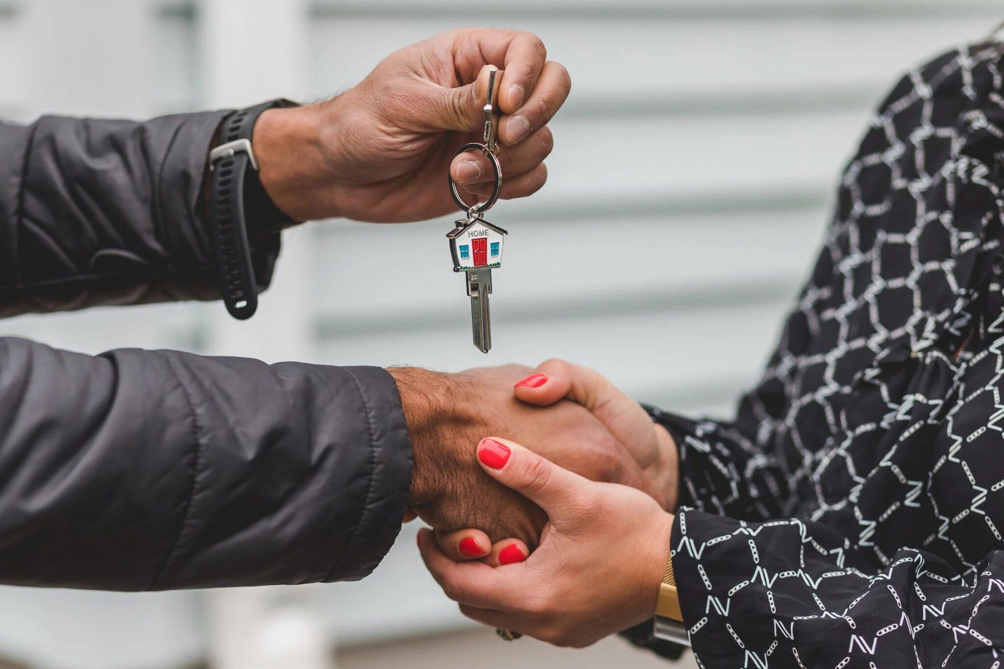 realtor-handing-the-keys-of-a-property-to-the-real-estate-client-1-2048x1365