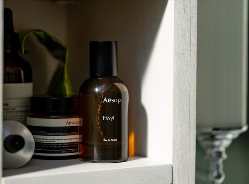 Bathroom shelf with a bottle of perfume 